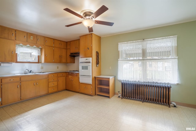 2006 Dixwell St, Davenport, IA 52802 - kitchen featuring radiator, oven, under cabinet range hood, ceiling fan, and a warming drawer