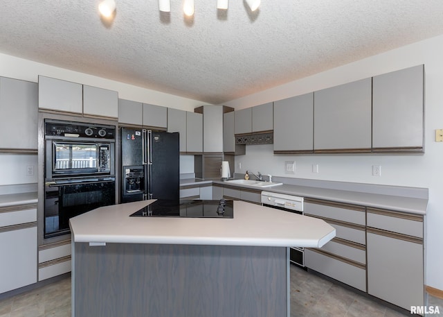 10 Lighthouse Ln Unit 10, Hampton, IL 61256 - kitchen with black appliances, gray cabinets, a sink, a textured ceiling, and light countertops