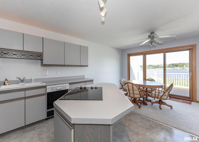 10 Lighthouse Ln Unit 10, Hampton, IL 61256 - kitchen with dishwasher, a sink, gray cabinets, black electric stovetop, and a center island