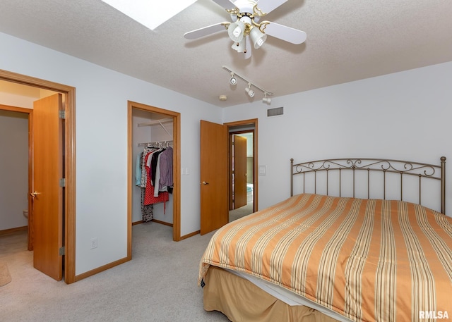 10 Lighthouse Ln Unit 10, Hampton, IL 61256 - bedroom with light carpet, a spacious closet, a textured ceiling, a closet, and baseboards