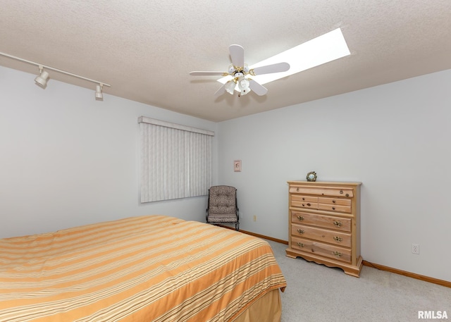 10 Lighthouse Ln Unit 10, Hampton, IL 61256 - bedroom featuring light carpet, a textured ceiling, baseboards, rail lighting, and a ceiling fan