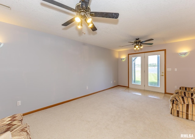 10 Lighthouse Ln Unit 10, Hampton, IL 61256 - unfurnished living room featuring light carpet, ceiling fan, baseboards, and a textured ceiling