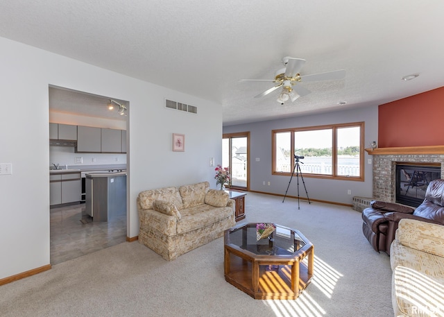 10 Lighthouse Ln Unit 10, Hampton, IL 61256 - living area with light colored carpet, a ceiling fan, and baseboards