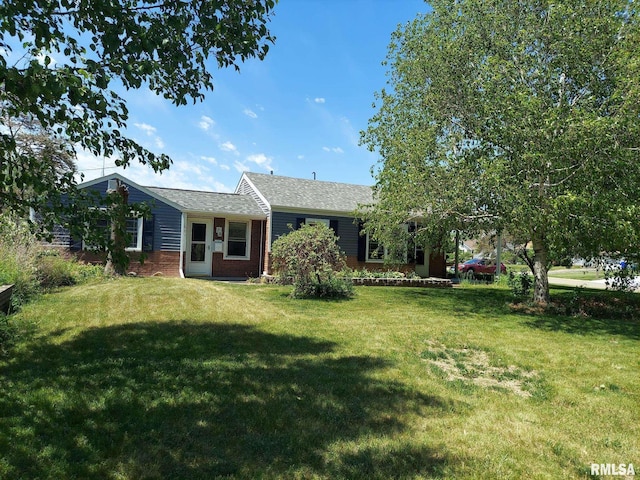 601 E St S, Kewanee, IL 61443 - back of house featuring a lawn, brick siding, and roof with shingles