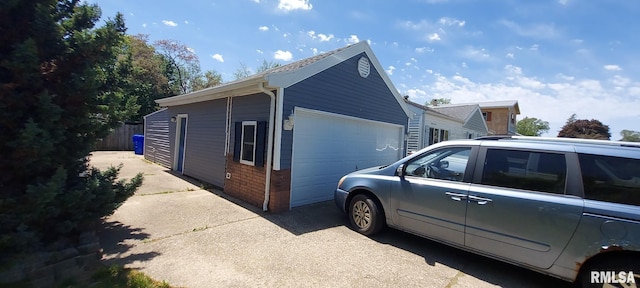 601 E St S, Kewanee, IL 61443 - view of side of property with brick siding, fence, and an outbuilding