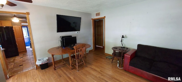 601 E St S, Kewanee, IL 61443 - office space featuring ceiling fan, light wood finished floors, baseboards, and a textured ceiling