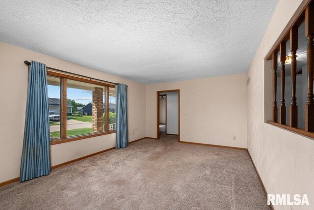 5117 Woodland Ave, Davenport, IA 52807 - empty room with carpet flooring, a textured ceiling, and baseboards