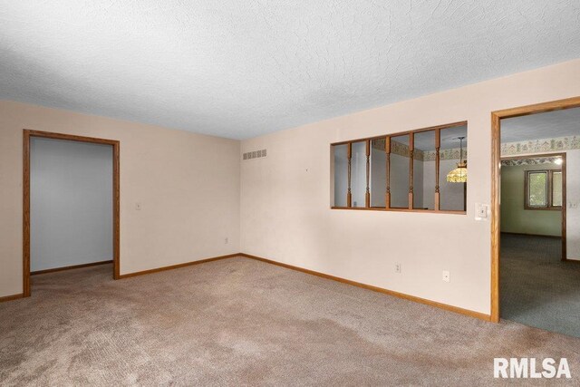 5117 Woodland Ave, Davenport, IA 52807 - carpeted spare room with baseboards and a textured ceiling
