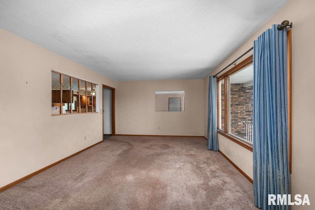 5117 Woodland Ave, Davenport, IA 52807 - spare room featuring carpet flooring, baseboards, and a textured ceiling