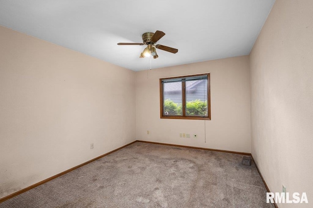 5117 Woodland Ave, Davenport, IA 52807 - spare room with carpet floors, baseboards, and a ceiling fan
