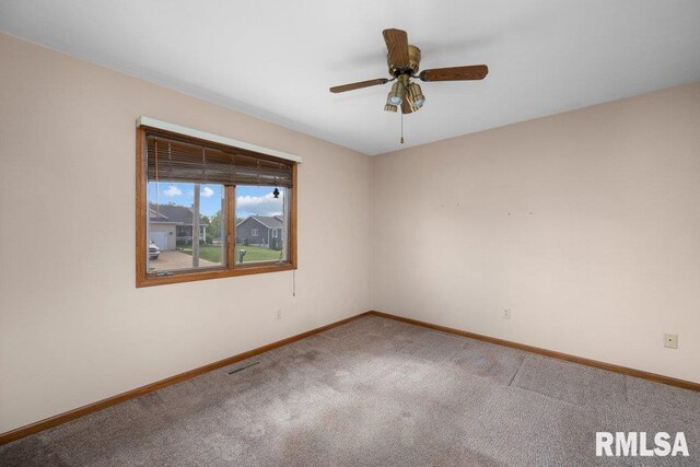 5117 Woodland Ave, Davenport, IA 52807 - unfurnished room with baseboards, carpet, and ceiling fan