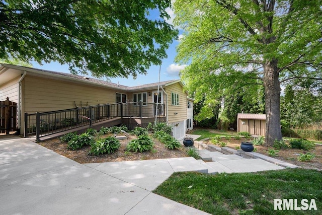 5117 Woodland Ave, Davenport, IA 52807 - ranch-style home featuring a deck and a patio