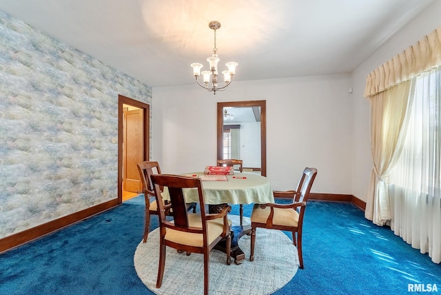 2707 Grand Ave, Davenport, IA 52803 - carpeted dining area featuring baseboards and a chandelier