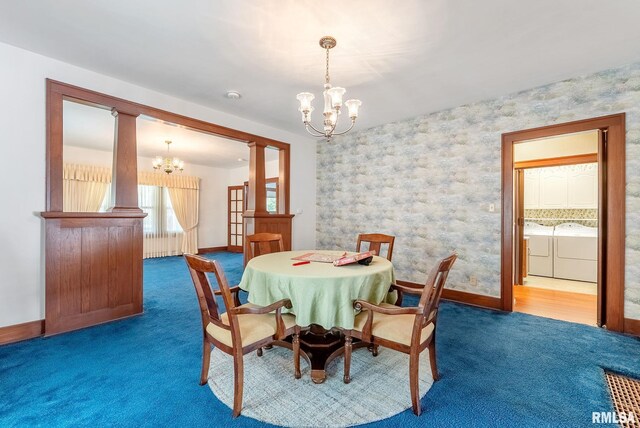 2707 Grand Ave, Davenport, IA 52803 - dining area featuring a chandelier, carpet flooring, washing machine and dryer, baseboards, and wallpapered walls