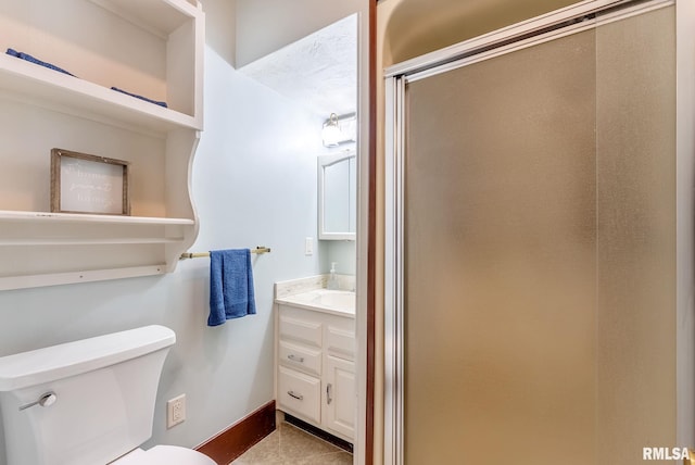 2707 Grand Ave, Davenport, IA 52803 - bathroom with toilet, baseboards, a shower stall, tile patterned floors, and vanity