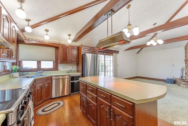 2707 Grand Ave, Davenport, IA 52803 - kitchen featuring appliances with stainless steel finishes, a sink, a chandelier, a kitchen island, and light countertops