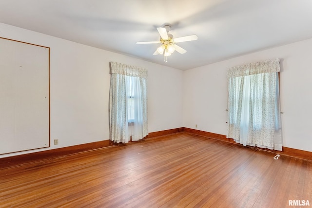 2707 Grand Ave, Davenport, IA 52803 - spare room with wood-type flooring, baseboards, and ceiling fan