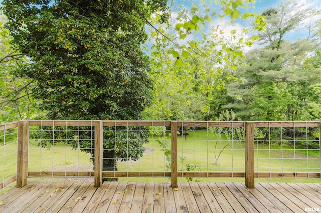 wooden terrace featuring a lawn