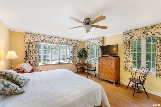 2615 12th St, Moline, IL 61265 - bedroom with light wood-style flooring, a ceiling fan, and baseboards
