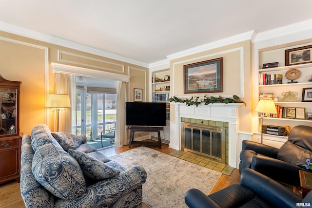 2615 12th St, Moline, IL 61265 - living area with ornamental molding, built in shelves, a tile fireplace, and wood finished floors