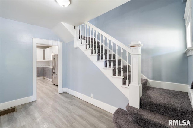 1720 Davie St, Davenport, IA 52804 - stairs featuring wood finished floors and baseboards