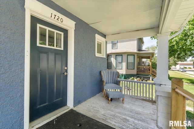 1720 Davie St, Davenport, IA 52804 - view of exterior entry with covered porch and stucco siding