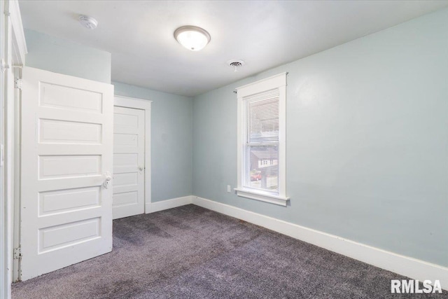 1720 Davie St, Davenport, IA 52804 - unfurnished room with dark carpet, baseboards, and a smoke detector