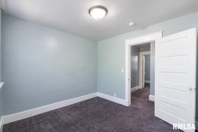 1720 Davie St, Davenport, IA 52804 - spare room featuring dark carpet and baseboards