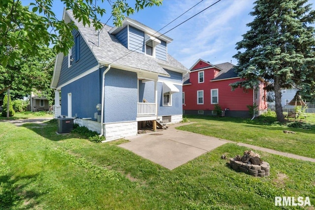 1720 Davie St, Davenport, IA 52804 - back of house with central AC, a fire pit, a lawn, roof with shingles, and a patio