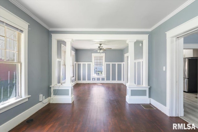 1720 Davie St, Davenport, IA 52804 - unfurnished room with decorative columns, a ceiling fan, wood finished floors, and ornamental molding