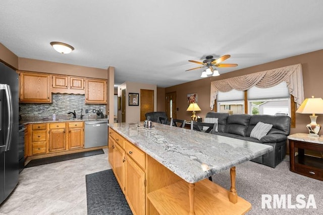 1005 17th St, Port Byron, IL 61275 - kitchen featuring dishwasher, ceiling fan, light stone countertops, a center island, and backsplash