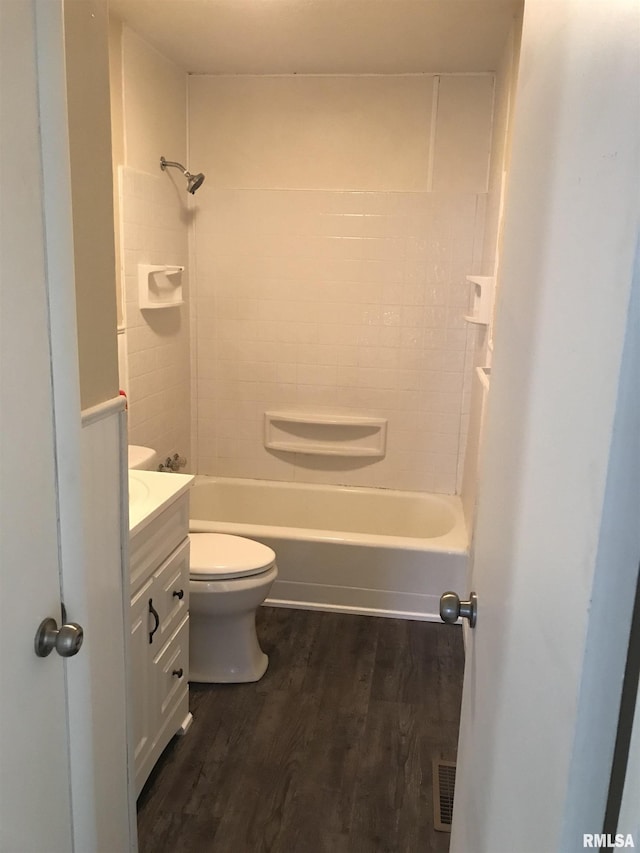 107 E Vermont St, Cambria, IL 62918 - bathroom with vanity, wood finished floors, toilet, and tub / shower combination