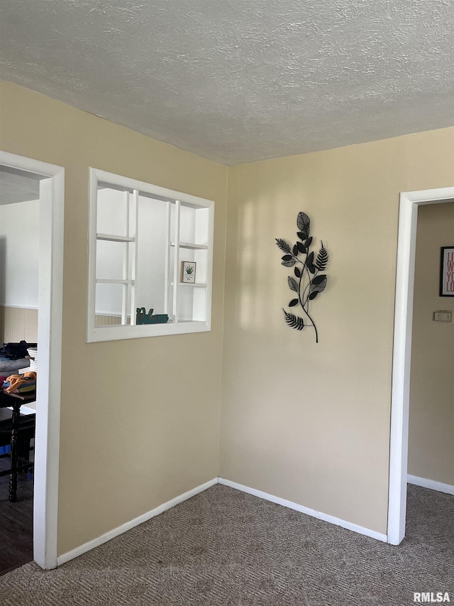 107 E Vermont St, Cambria, IL 62918 - spare room with carpet flooring, baseboards, and a textured ceiling