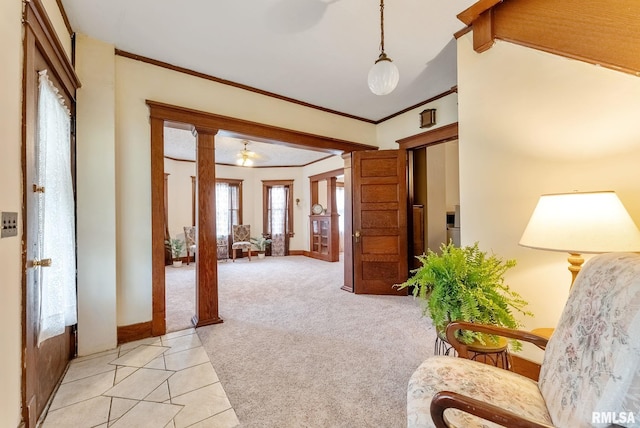 314 W Locust St, Cambridge, IL 61238 - entrance foyer featuring light colored carpet, crown molding, baseboards, ornate columns, and light tile patterned flooring