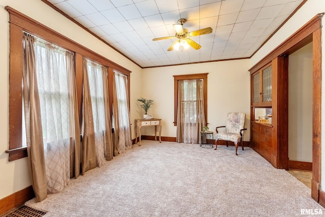 314 W Locust St, Cambridge, IL 61238 - sitting room featuring ornamental molding, ceiling fan, light carpet, and baseboards