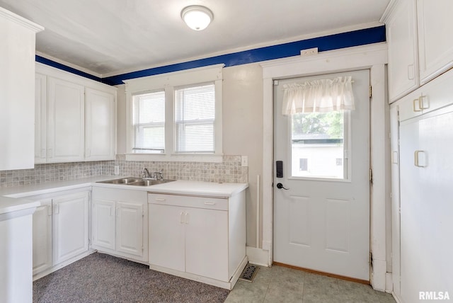 110 NW 3rd Ave, Aledo, IL 61231 - kitchen featuring a sink, backsplash, white cabinets, and light countertops