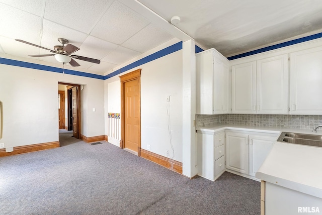 110 NW 3rd Ave, Aledo, IL 61231 - kitchen with a ceiling fan, white cabinets, a sink, carpet floors, and backsplash