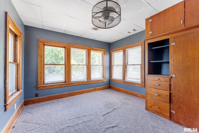 110 NW 3rd Ave, Aledo, IL 61231 - spare room with carpet flooring, baseboards, a ceiling fan, and a drop ceiling