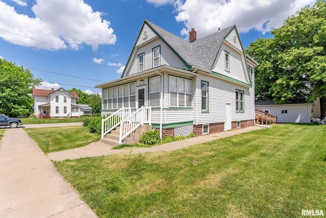 110 NW 3rd Ave, Aledo, IL 61231 - view of front of house featuring roof with shingles, a front lawn, a sunroom, and a chimney
