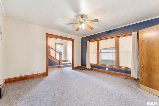 110 NW 3rd Ave, Aledo, IL 61231 - carpeted empty room featuring ceiling fan, stairs, baseboards, and crown molding
