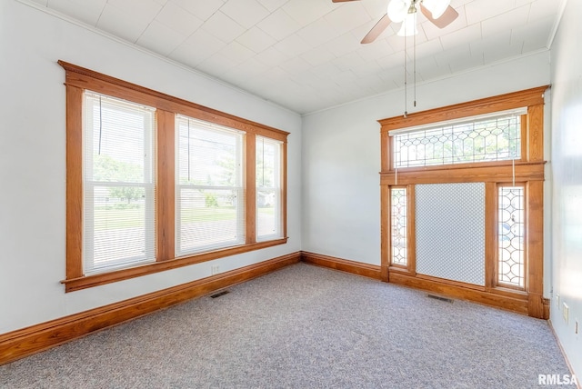 110 NW 3rd Ave, Aledo, IL 61231 - spare room featuring plenty of natural light, ornamental molding, carpet, ceiling fan, and baseboards