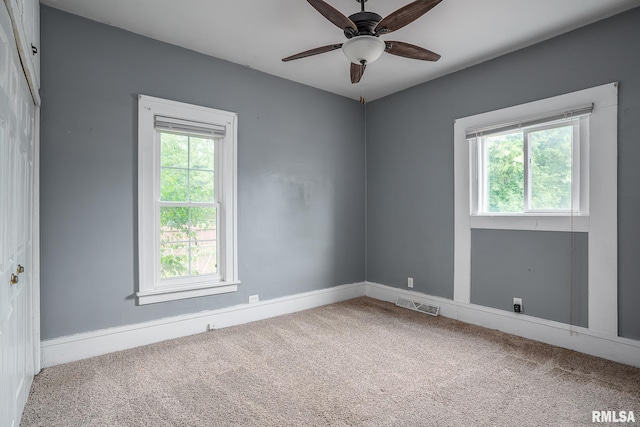 2721 11th Ave Unit B, Moline, IL 61265 - carpeted spare room featuring plenty of natural light, ceiling fan, and baseboards
