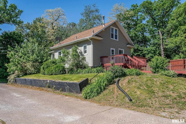 2721 11th Ave Unit B, Moline, IL 61265 - view of home's exterior with a wooden deck and a lawn