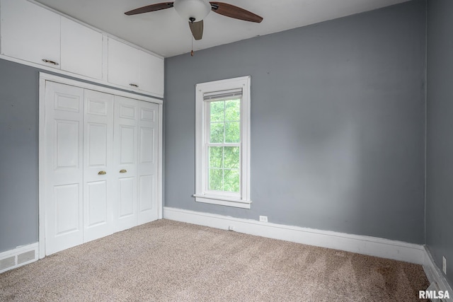 2721 11th Ave Unit B, Moline, IL 61265 - unfurnished bedroom featuring carpet flooring, a closet, baseboards, and ceiling fan
