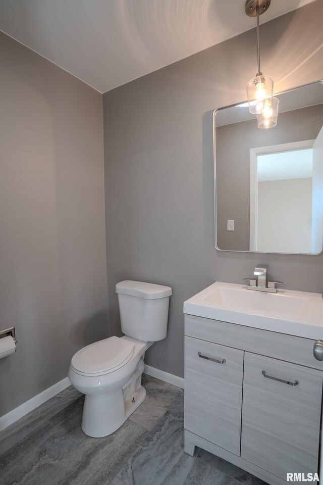 8501 49th St, Coal Valley, IL 61240 - bathroom featuring baseboards, toilet, and vanity