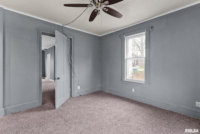 706 8th St, De Witt, IA 52742 - carpeted empty room with ceiling fan, baseboards, and crown molding