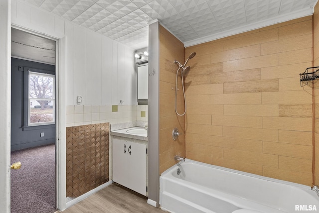 706 8th St, De Witt, IA 52742 - bathroom featuring bathtub / shower combination, vanity, and wood finished floors
