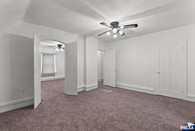 706 8th St, De Witt, IA 52742 - unfurnished bedroom with carpet flooring, arched walkways, ceiling fan, and lofted ceiling