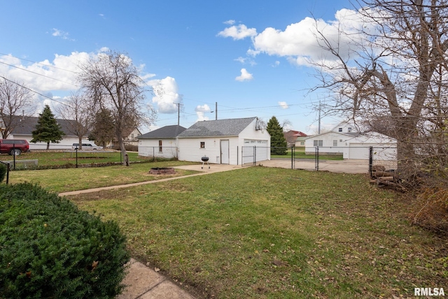706 8th St, De Witt, IA 52742 - view of yard with an outbuilding, concrete driveway, and a gate