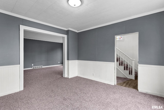 706 8th St, De Witt, IA 52742 - carpeted empty room featuring wainscoting, crown molding, and stairway